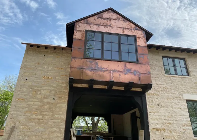 Copper metal panel facade on a stone building for Metal Roof Coating in Topeka