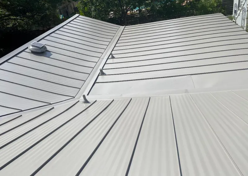 Solar attic fan installed on a metal roof for Roof Ventilation in Topeka